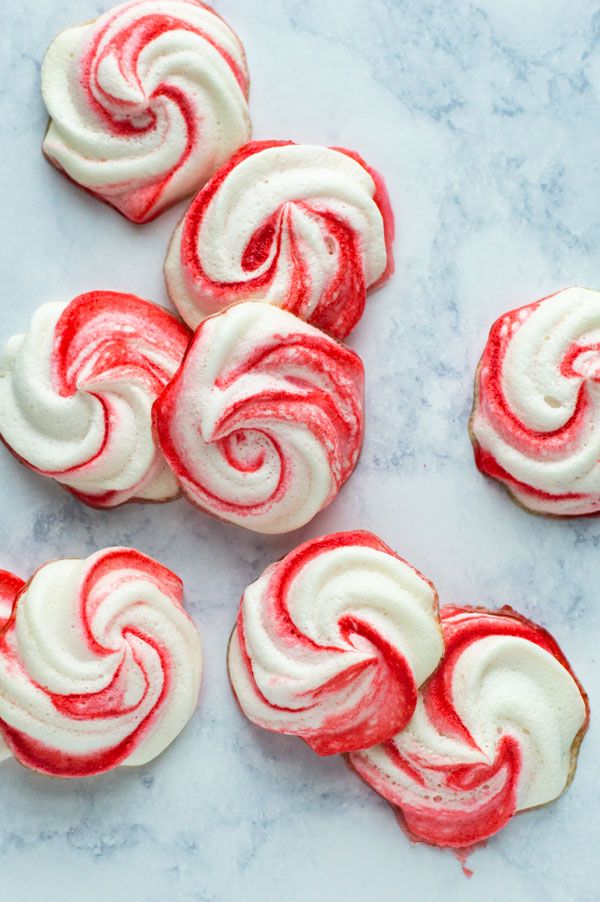 red and white swirl cookies on a marble surface