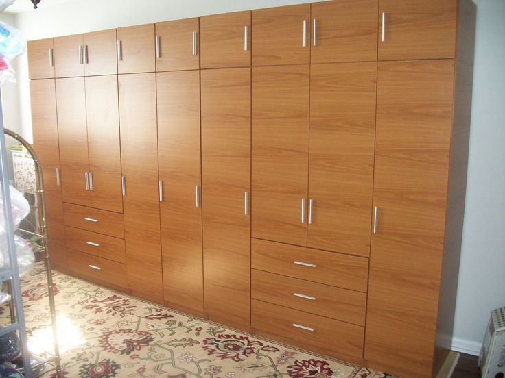 a large wooden cabinet in a room with carpeting on the floor and other furniture