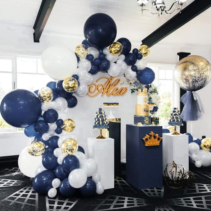 balloons, cake and decorations are on display in an elegantly decorated room with black carpet