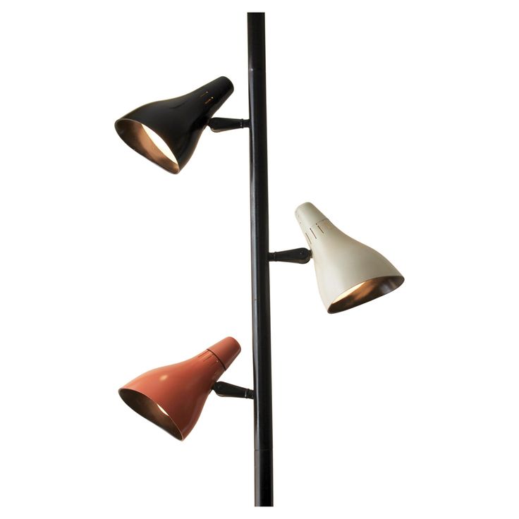 three different colored lamps on a black pole