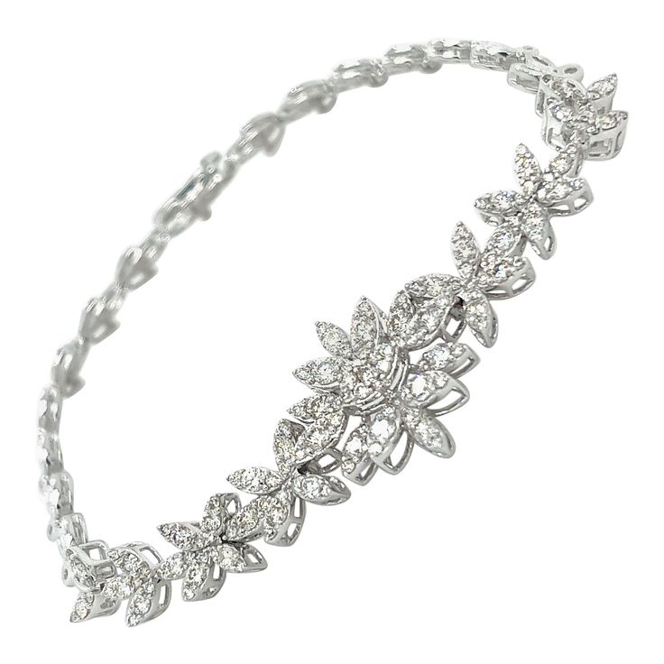 18K White Gold Classic Diamond Bracelet 18K White Gold - 12.12 GM 135 Diamonds - 1.972 CT This exquisite 18K white gold bracelet features a timeless, classic design accentuated by the stunning brilliance of 1.972 carats of high-quality diamonds. The sleek, polished links create a sophisticated and elegant look that will instantly elevate any outfit. Crafted with exceptional attention to detail, this dazzling diamond bracelet is a true heirloom piece that will be cherished for generations. The cl Luxury White Gold Bracelet With Intricate Design, Luxury White Gold Oval Diamond Bracelet, Classic Evening Platinum Bracelets, Dazzling Formal Diamond Bangle Bracelet, Exquisite Formal Bangle Diamond Bracelet, Formal White Gold Cubic Zirconia Diamond Bracelet, Elegant Cubic Zirconia Tennis Bracelet For Formal Occasions, Elegant Cubic Zirconia Diamond Bracelet For Evening, Dazzling Diamond Bangle Bracelet For Formal Occasion