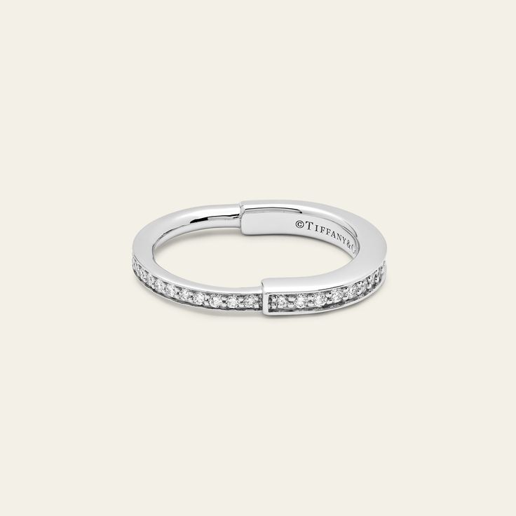 Tiffany & Co. Lock Ring in White Gold with Pavé Diamonds The Tiffany & Co. Lock ring is a bold symbol of unity and diversity, celebrating personal connections that shape us. Crafted in 18k white gold with round brilliant diamonds totaling 0.36 carats, this ring is a stylish choice whether worn alone or as part of your everyday ring collection. Details 18k White Gold TTL Carat: 0.36ct Size: 6 Product Number: 72792092 Unity In Diversity, Everyday Rings, Watch Necklace, Ring Collections, Tiffany & Co., Ring Bracelet, Pave Diamonds, Jewelry Care, Light Box