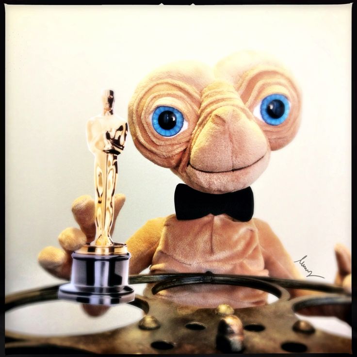 a stuffed animal holding an award on top of a table