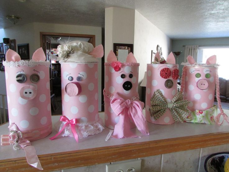 some pink and white polka dot paper bags with pig faces on them sitting on a counter