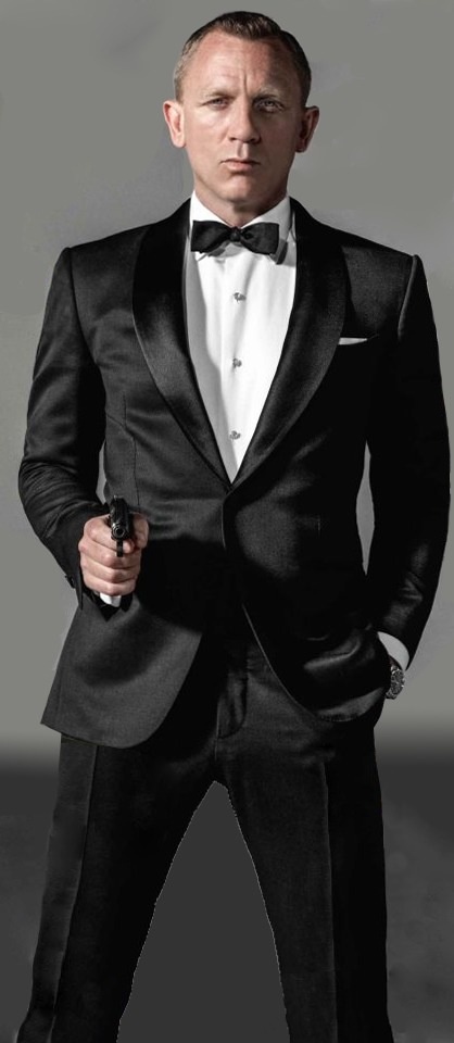 a man in a tuxedo is posing for a photo with his hands on his hips