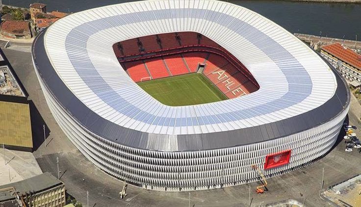 an aerial view of a soccer stadium with red and white stripes on the sidelines