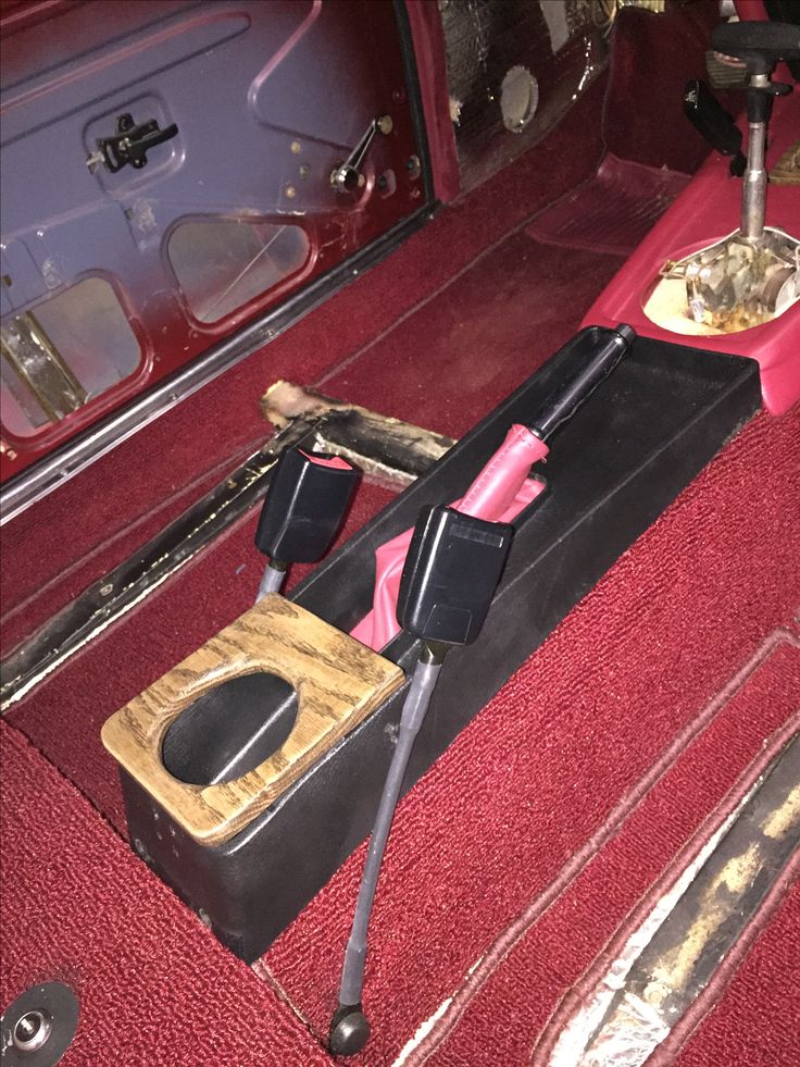 the interior of an old car with tools in it