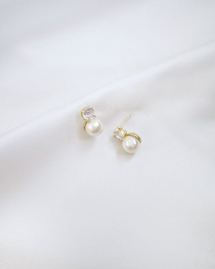 A delicate pair of pearl stud earring accented with sparkling rhinestones creates an elegant and versatile style, suitable for both formal occasions and everyday wear. Perfect for date night, wedding, bridesmaids, holiday party, and any special occasions. DETAILS: MEASUREMENT: 0.5" LENGTHCOLOR: GOLDIMPORTED MATERIALS Dainty Akoya Pearl Earrings For Formal Occasions, Dainty White Akoya Pearl Earrings, 14k Gold-filled Pearl Earrings For Wedding, Elegant 14k Gold-filled Pearl Earrings For Formal Occasions, White 14k Gold-filled Pearl Earrings For Wedding, Night Wedding, Pearl Stud Earrings, Pearl Studs, Stud Earring