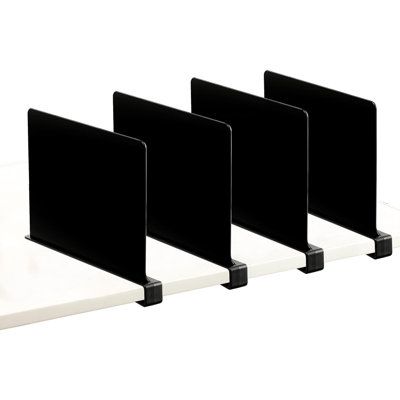 three black and white bookshelves are lined up against each other on a white surface