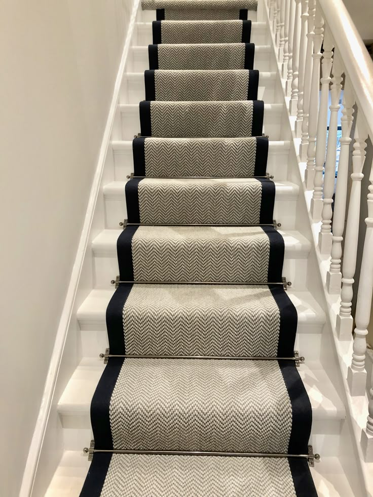 a set of stairs with black and white carpet