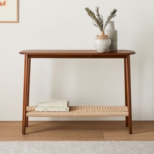 a wooden table with two vases on top of it and a shelf underneath the table