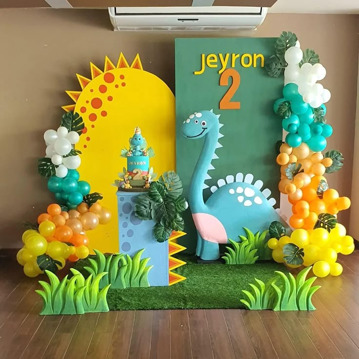 a dinosaur themed birthday party with balloons and decorations