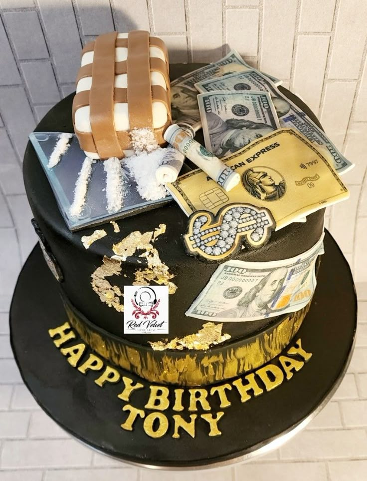 a birthday cake with money and other items on it