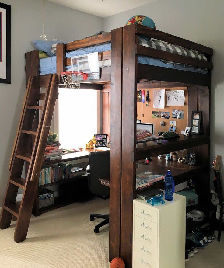 there is a loft bed with a desk underneath it and a ladder to the top