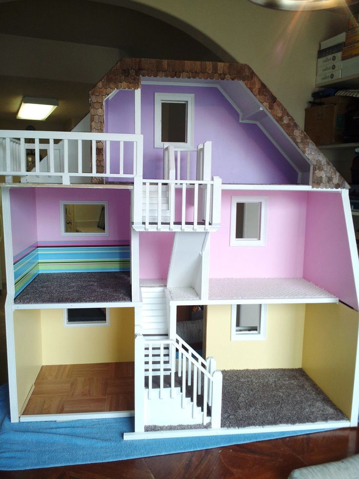 a doll house with stairs to the second floor