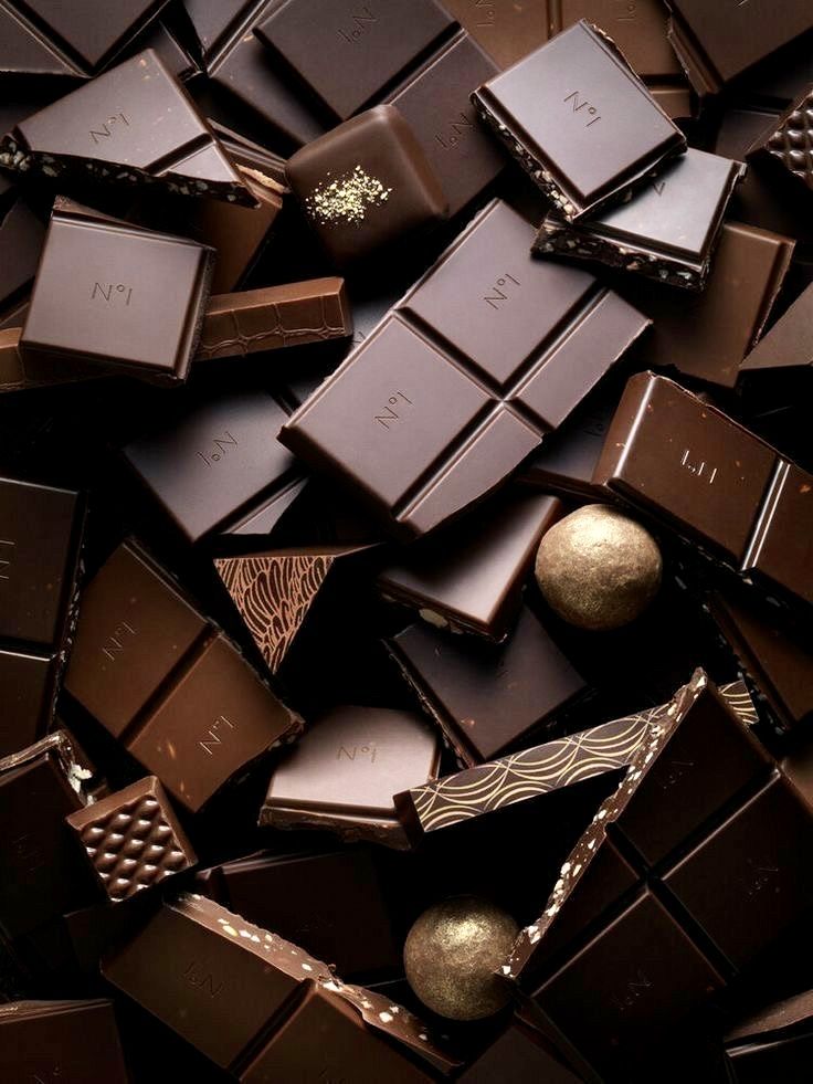 many different types of chocolates are stacked on top of each other