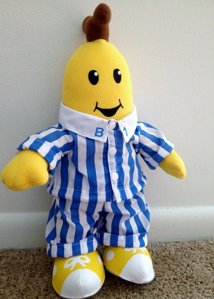 a yellow stuffed animal with a blue and white striped shirt on it's chest