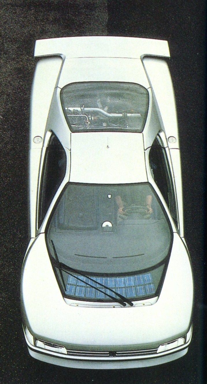 an overhead view of a white car with its hood open