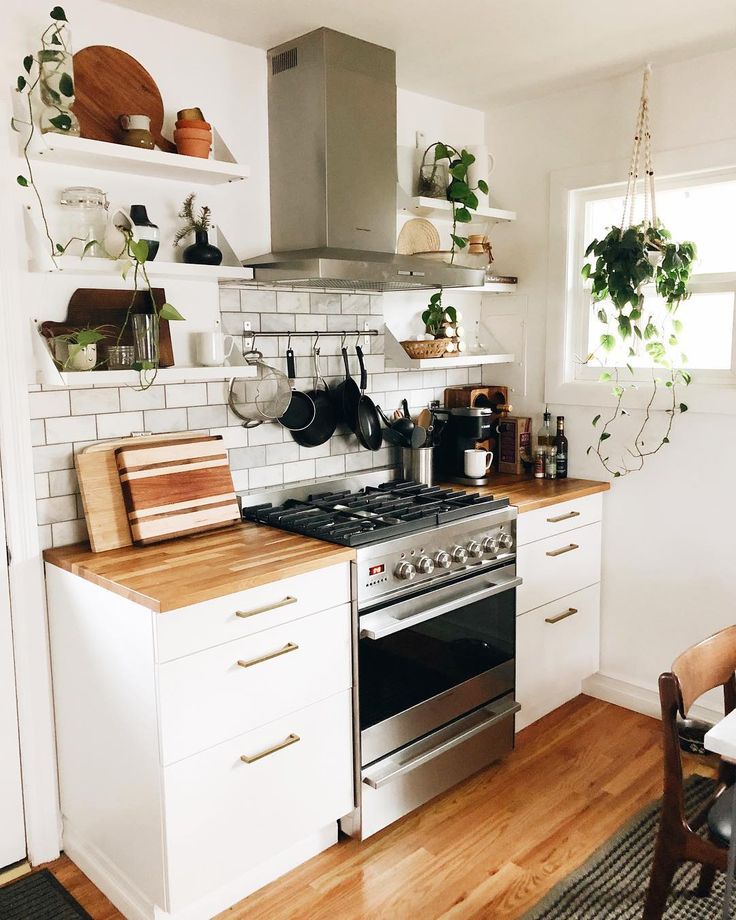 a kitchen with an oven, stove and counter top in the middle of the room