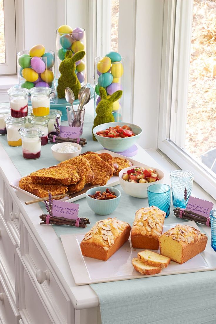 a table topped with lots of different types of food and desserts on top of it