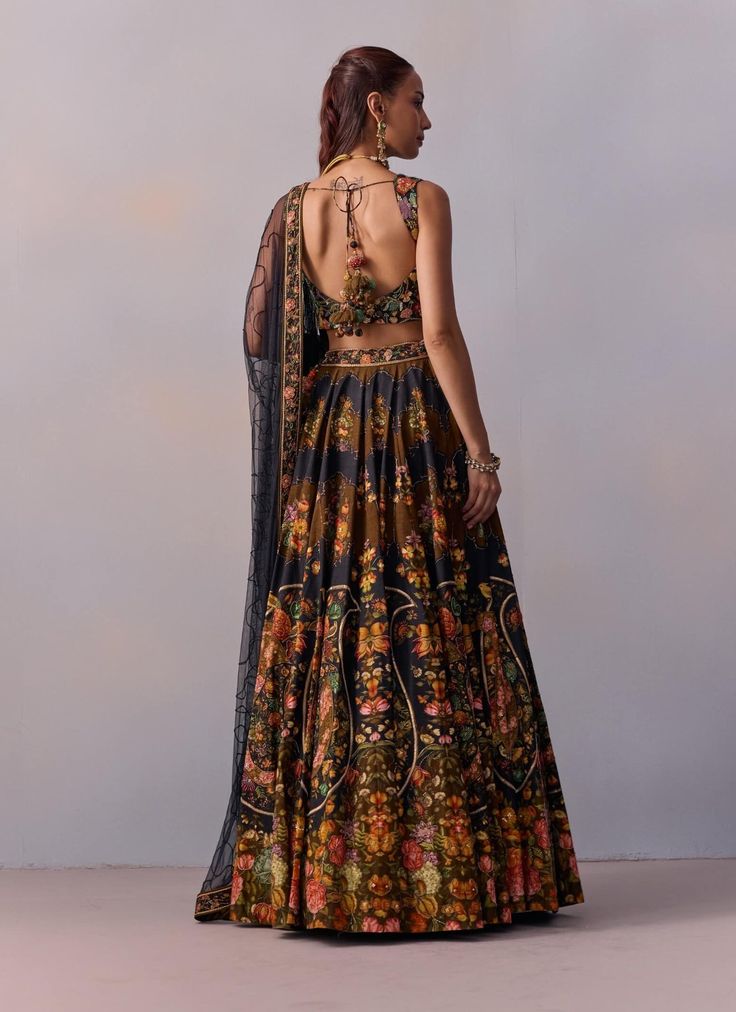 Presenting a contemporary twist on the classic lehenga design, this set features vintage floral and paisley motifs that add a unique charm. Paired with a stylish blouse showcasing a V-shaped neckline and heavy hand embroidery detailing, it beautifully blends tradition with modern flair. Adorn yourself in this vibrant floral ensemble that captures the essence of modern sophistication. Bollywood Style Lehenga With Printed Motifs For Reception, Traditional Floral Print Sets For Transitional Season, Festive Floral Print Sets For Reception, Unstitched Floral Anarkali Set For Reception, Fitted Anarkali Set With Printed Motifs For Reception, Designer Semi-stitched Choli With Floral Print, Traditional Designer Choli With Floral Print, Designer Semi-stitched Floral Print Choli, Reception Lehenga With Printed Motifs Semi-stitched