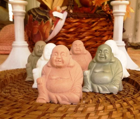 small buddha statues sitting on top of a wicker basket