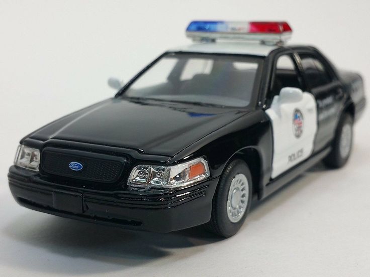 a toy police car on a white surface