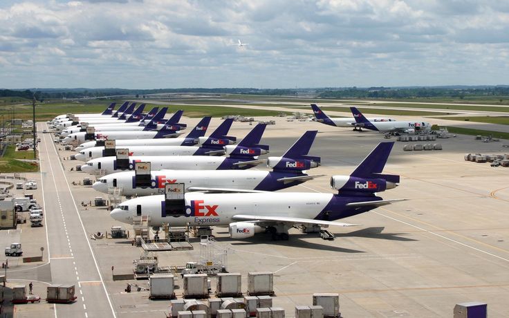 several planes parked on the tarmac at an airport