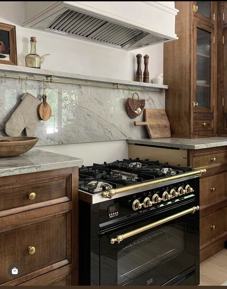 a stove top oven sitting inside of a kitchen next to wooden cabinets and counter tops