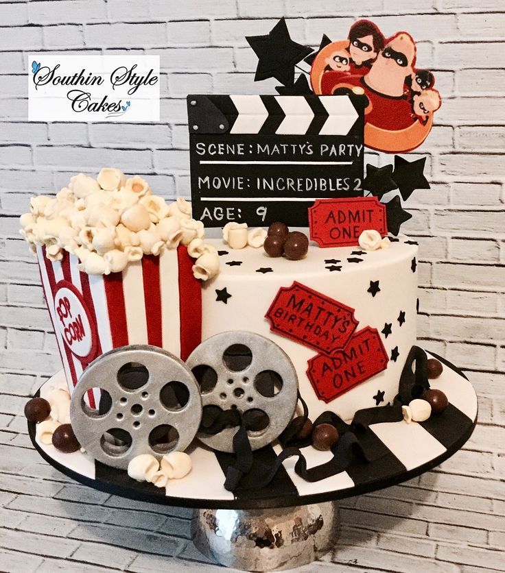 a movie themed birthday cake with popcorn and film reel