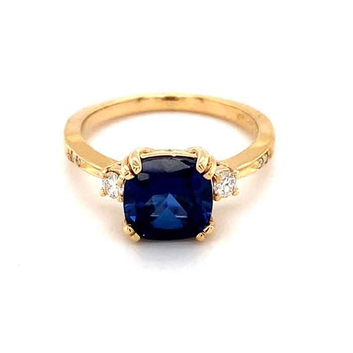 a blue sapphire and diamond ring on a white background