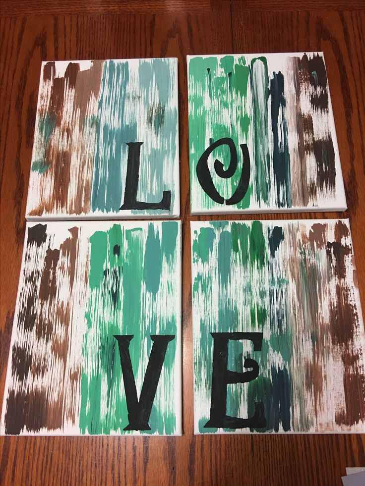 four pieces of wood that have the words love painted on them with green and brown paint