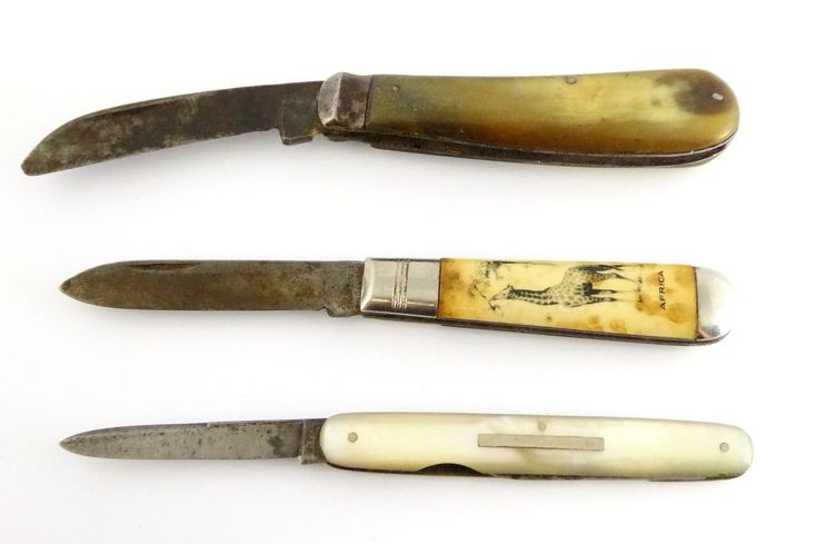 three different types of knifes on a white surface