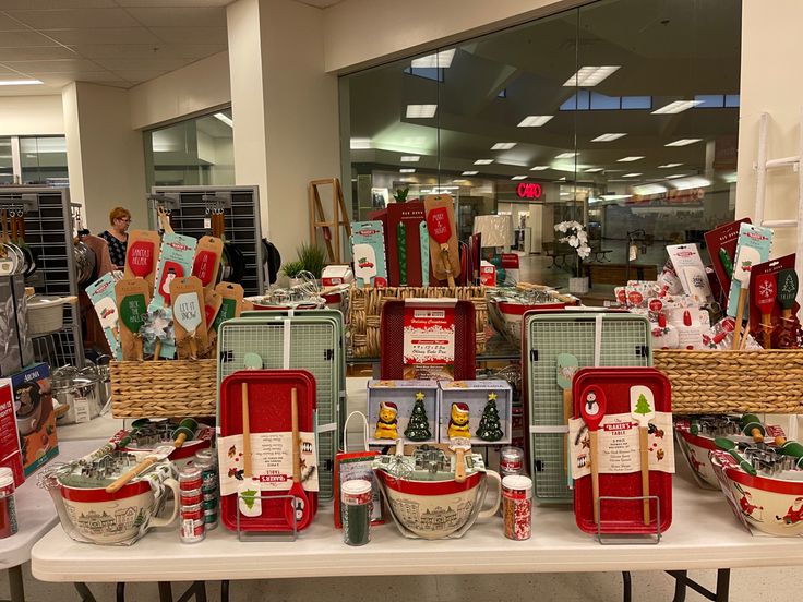 a table filled with lots of red and white christmas gifts on it's sides