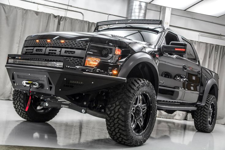 a large black truck parked in a garage