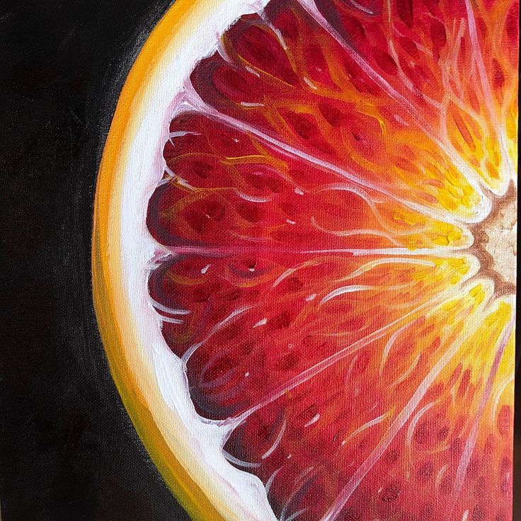 a painting of a grapefruit cut in half on a black background with yellow and red highlights