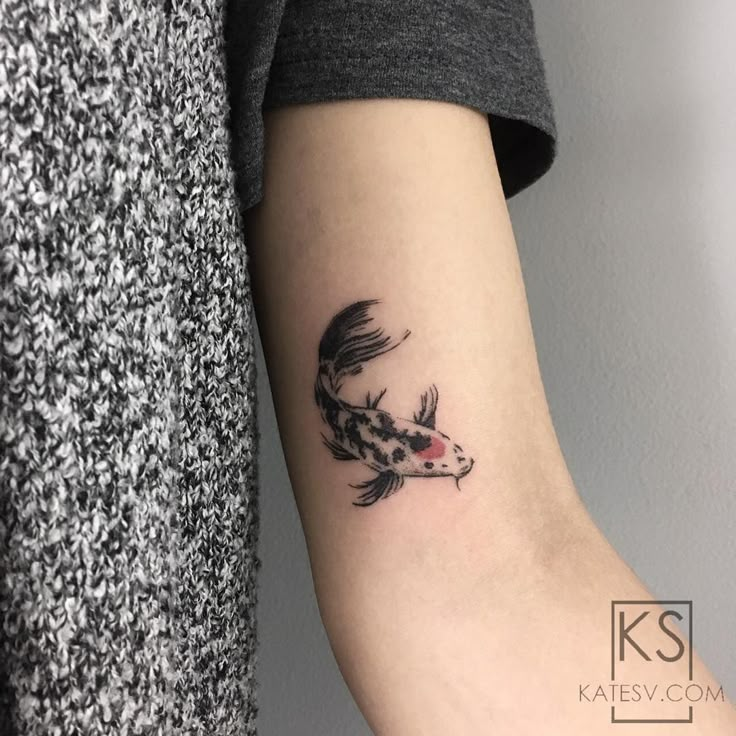 a koi fish tattoo on the arm