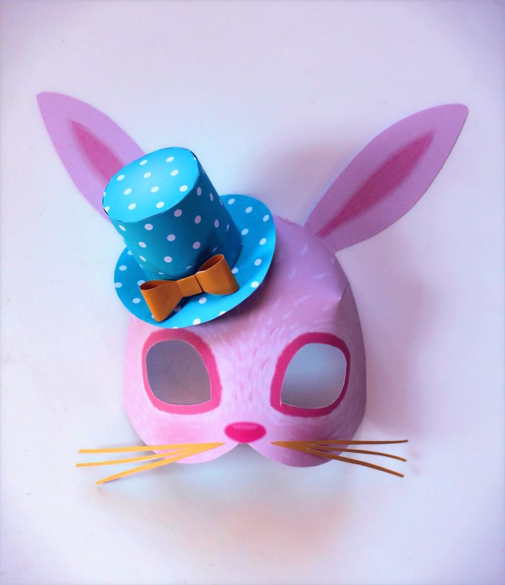 a pink bunny mask with a blue polka dot top hat on it's head