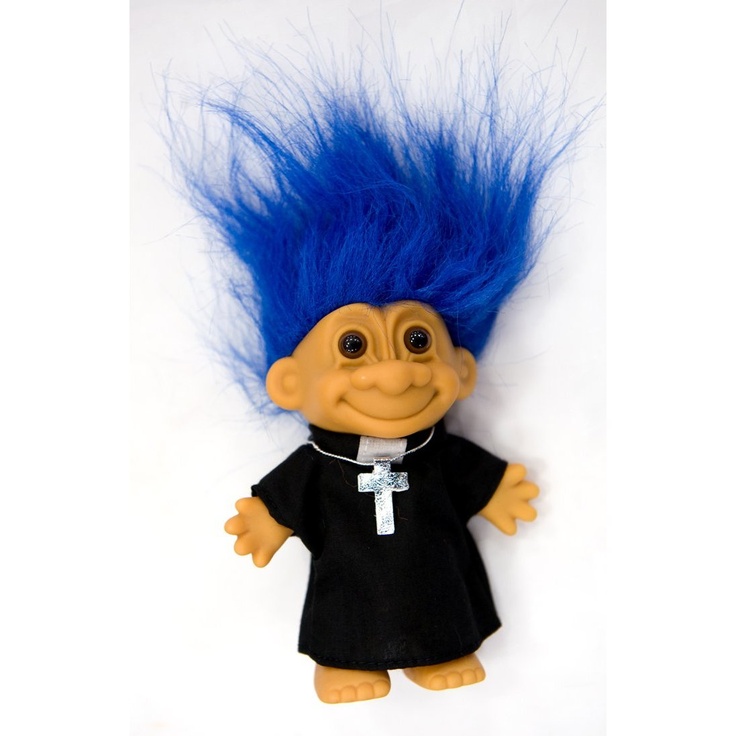 a stuffed animal with blue hair and black dress