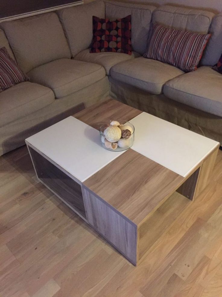 a living room with couches and a coffee table in the middle on hardwood flooring