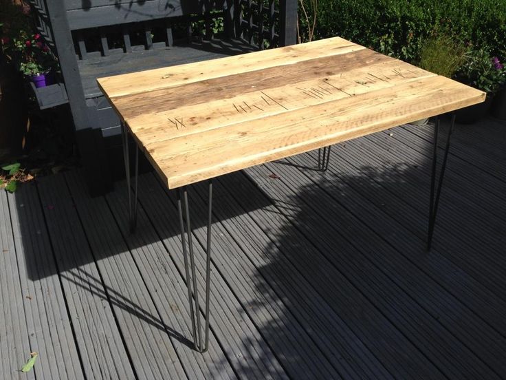 a wooden table sitting on top of a wooden deck