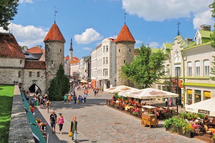 people are walking down the street in an old town