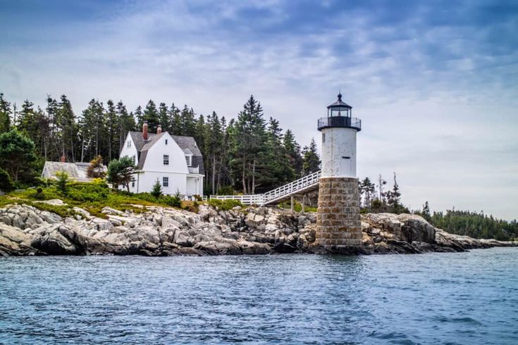 a lighthouse on an island surrounded by trees