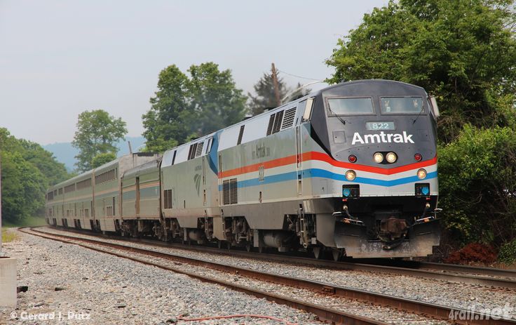 an amtrak train is traveling down the tracks