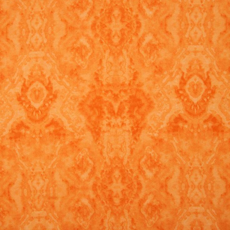 an orange rug with many different designs on it