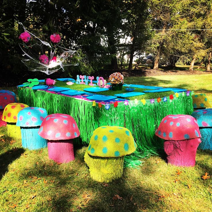 the table is covered with grass and colorful decorations