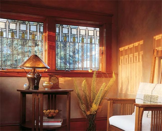 a chair and table in a room with stained glass windows