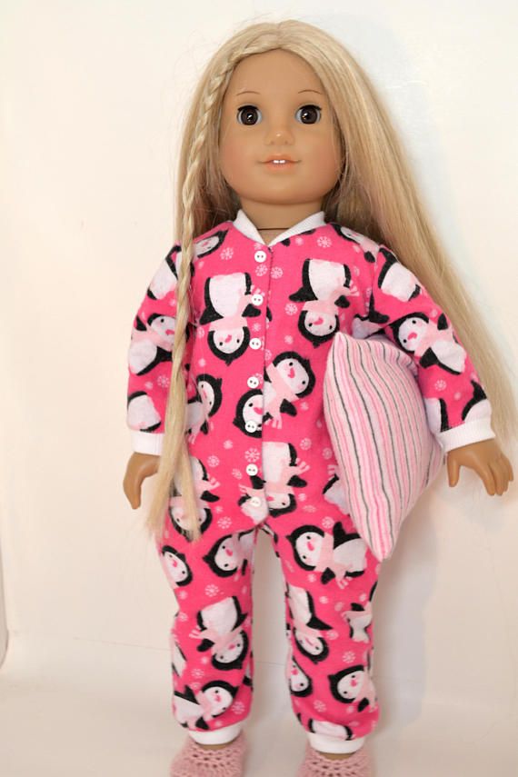 a doll with blonde hair wearing pink pajamas