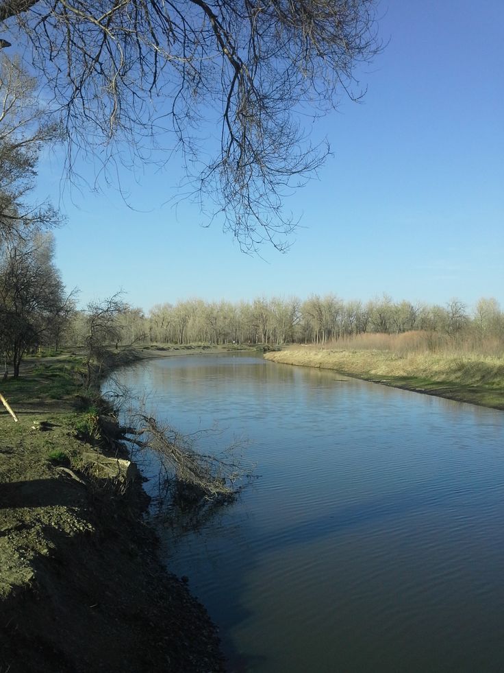 there is a small river running along the side of the road that goes to the other side