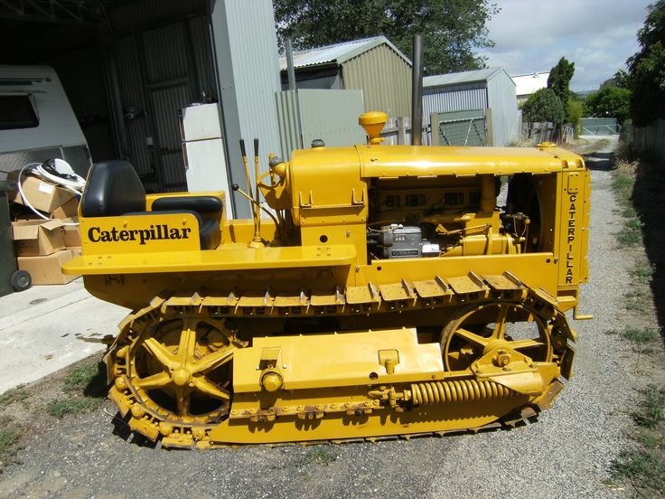 a yellow bulldozer parked in front of a building